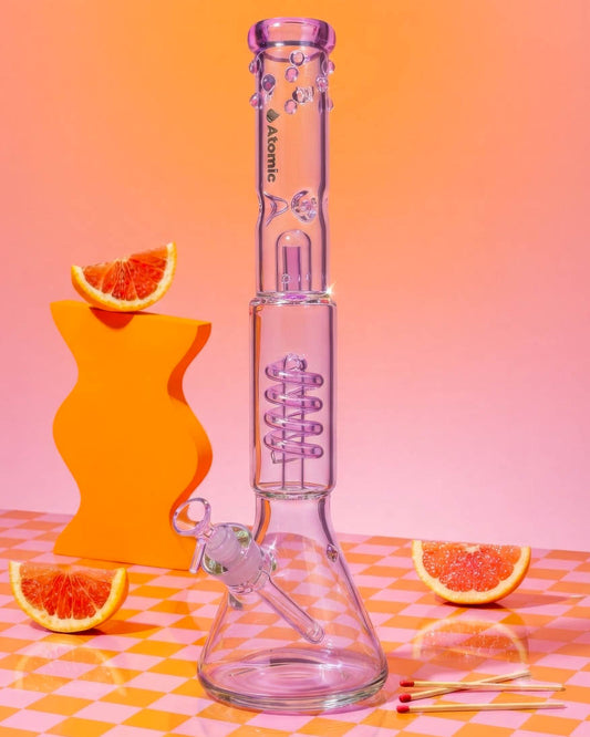 Clear 18-inch Atomic Glass beaker bong with pink accents, decorative bubble details, spiral coil perc, wide base, and removable 14mm glass bowl.