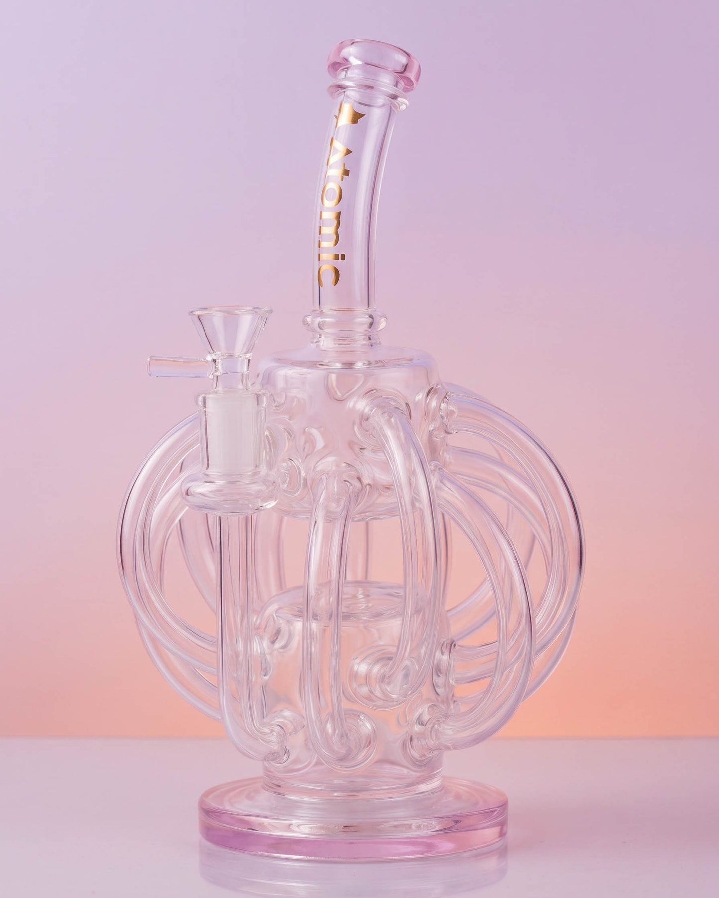 Clear 10-inch Atomic Glass recycler bong with looping octopus-inspired glass arms, curved neck, round base, and removable 14mm glass bowl.