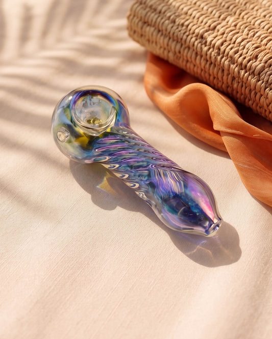 4.5-inch rainbow iridescent glass hand pipe with twisted helix detailing, rounded bowl, side carb, and shimmering blue, purple, pink, and gold tones.