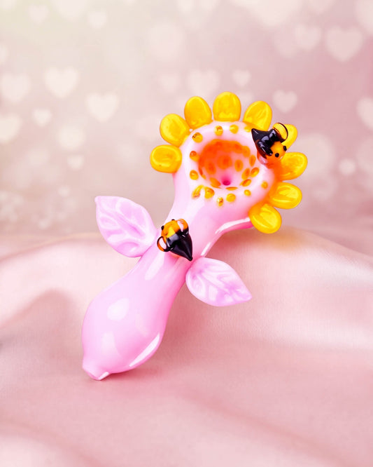 Pink 5-inch flower glass hand pipe with yellow sunflower petals, pink leaves, and sculpted bumblebee details.