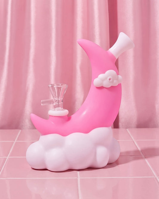Pink crescent moon silicone bong with white cloud base, small cloud accent, angled mouthpiece, and removable 14mm glass bowl.