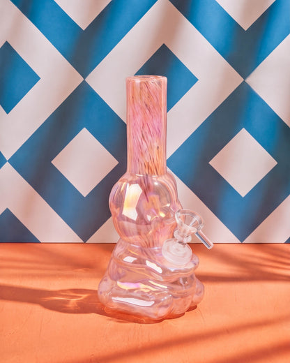 Pink iridescent 8-inch bear-shaped glass bong with swirled neck, rounded chamber, sculpted base, and clear slider bowl.
