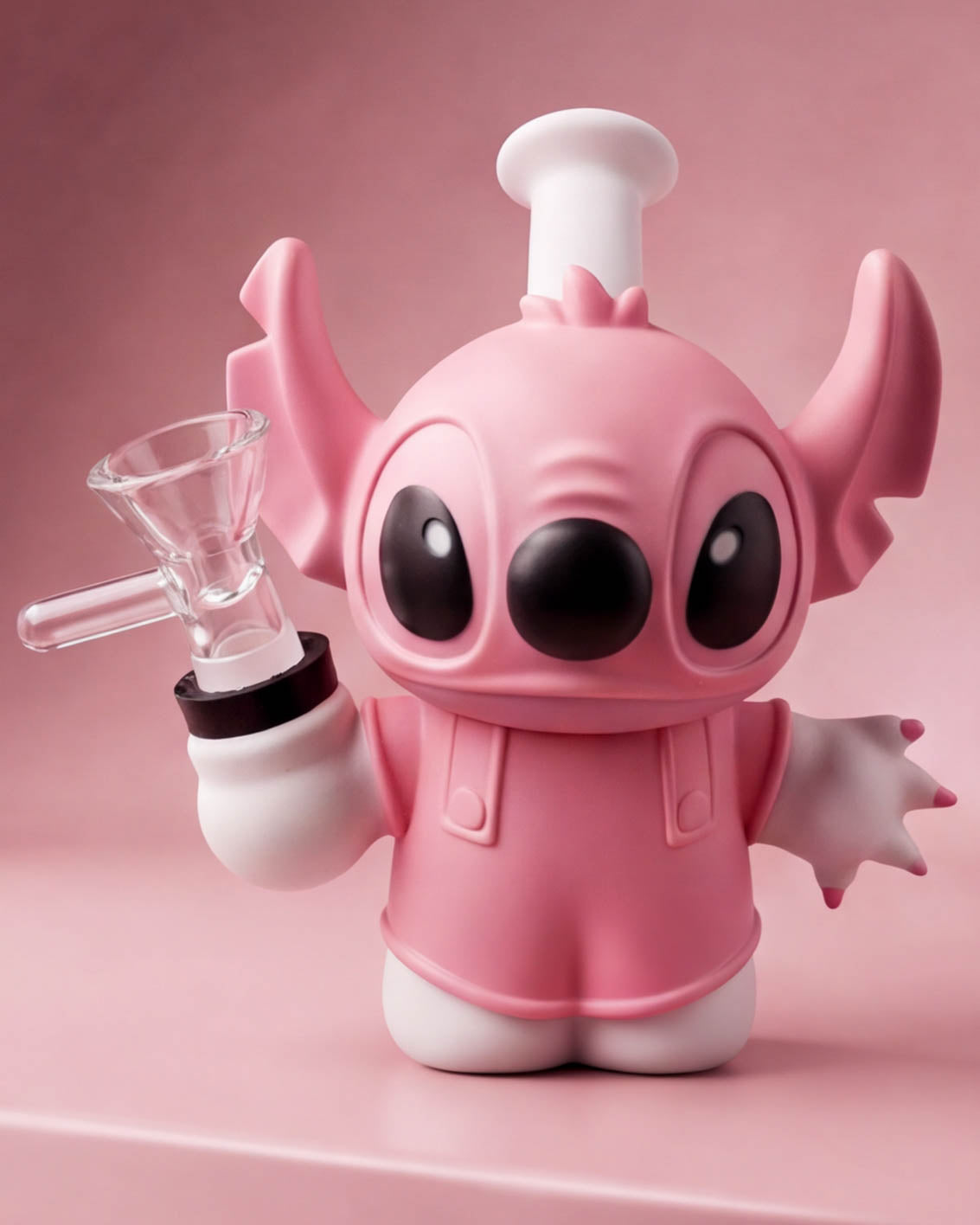 Pink 5-inch little monster silicone bong with oversized ears, big black eyes, white accents, and removable 14mm glass bowl.