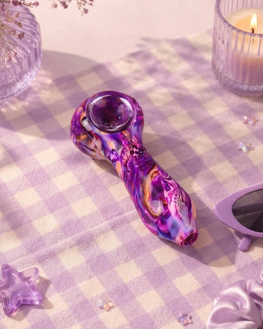 Purple 4-inch glass hand pipe with swirling pink, violet, white, and amber nebula-style colors, rounded bowl, and side carb.