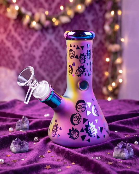 Iridescent Rick and Morty mini beaker bong with black character graphics, rainbow accents, and a clear 14mm bowl on purple velvet.