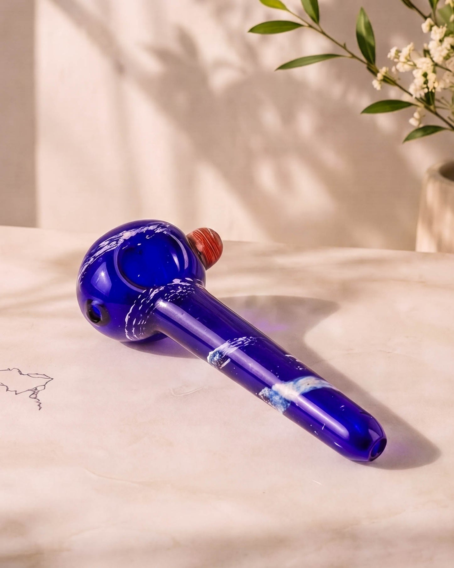 Cobalt blue 5-inch fumed glass hand pipe with white stardust-style accents, rounded bowl, side carb, and smooth mouthpiece.